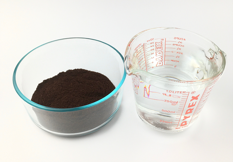 glass bowl with coffee grounds and measuring cup with water