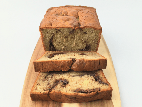 Nutella swirl banana bread with two slices cut to show dollops of Nutella in the middle of the slice