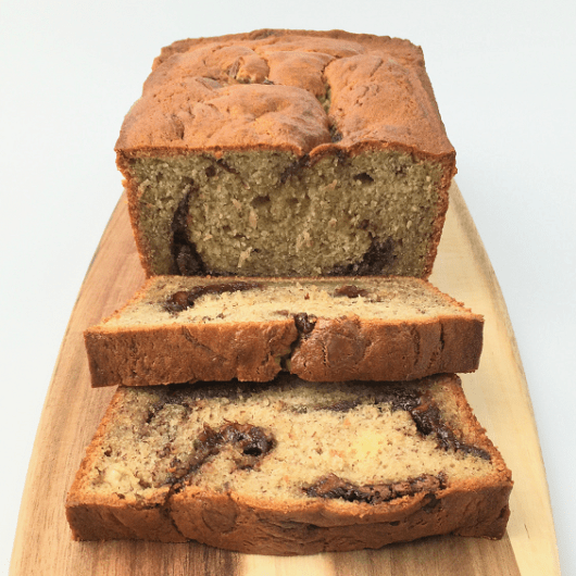 Nutella swirl banana bread with two slices cut to show dollops of Nutella in the middle of the slice