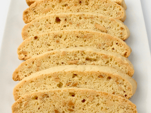 Vanilla almond biscotti arranged in a row on a white plate