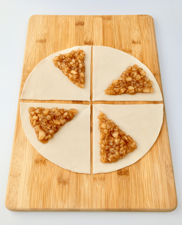 Pie crust cut into 4 pieces and topped with apple filling