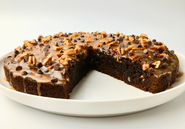 Finished caramel pecan brownie cake with one slice removed