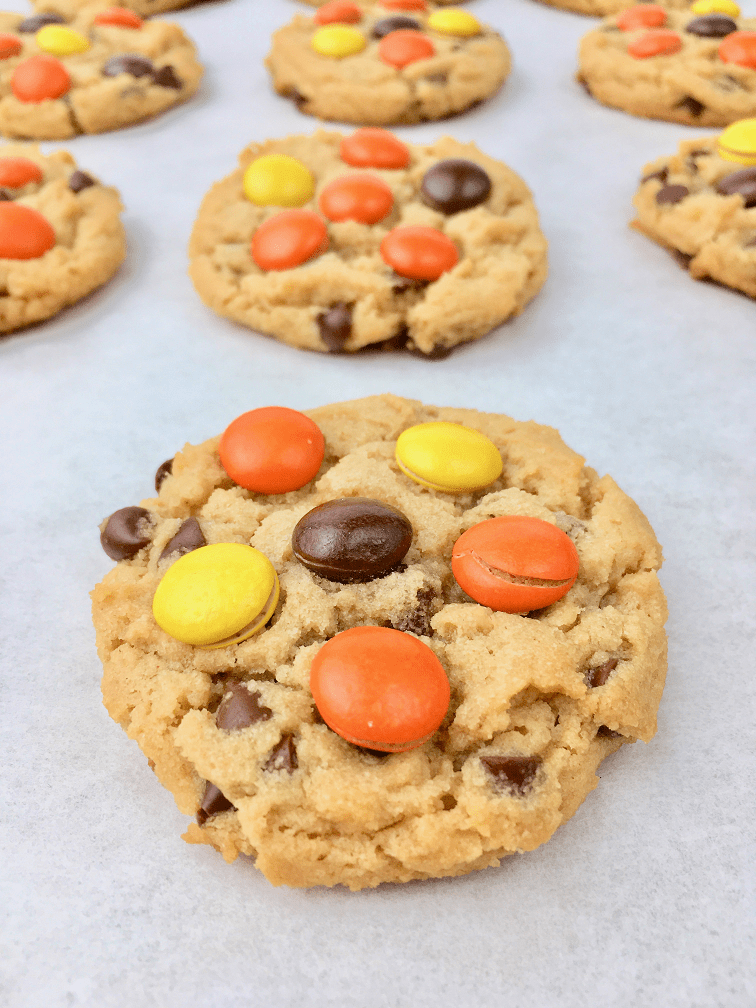 Baked Reese's pieces peanut butter cookies on a baking sheet