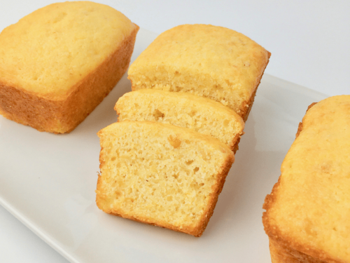 Side view of sliced sweet cornbread showing bits of corn