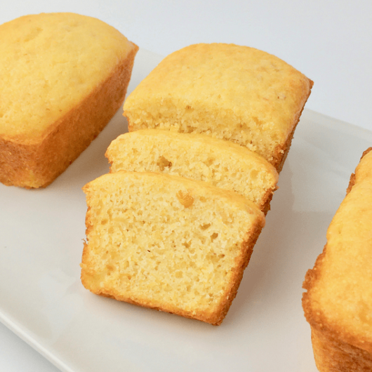 Side view of sliced sweet cornbread showing bits of corn