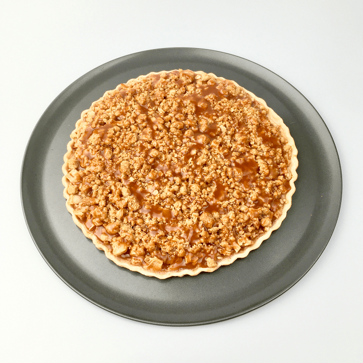 Baked apple pie pizza on a pizza pan