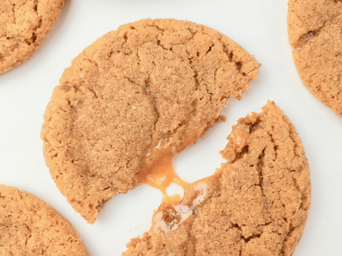 Caramel macchiato cookie split in half with melted caramel center