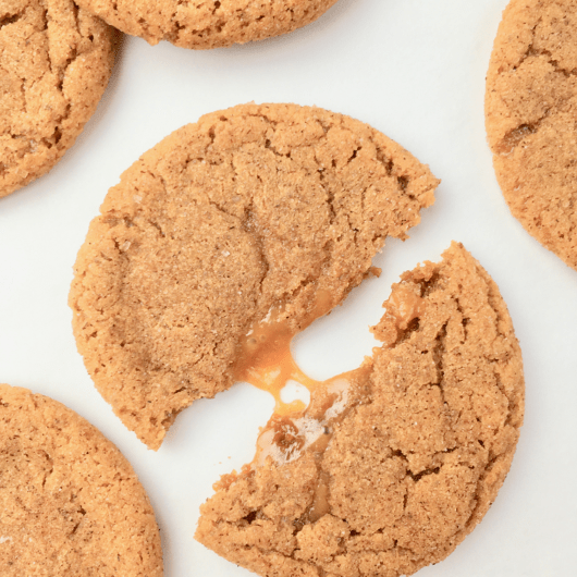 Caramel macchiato cookie split in half with melted caramel center