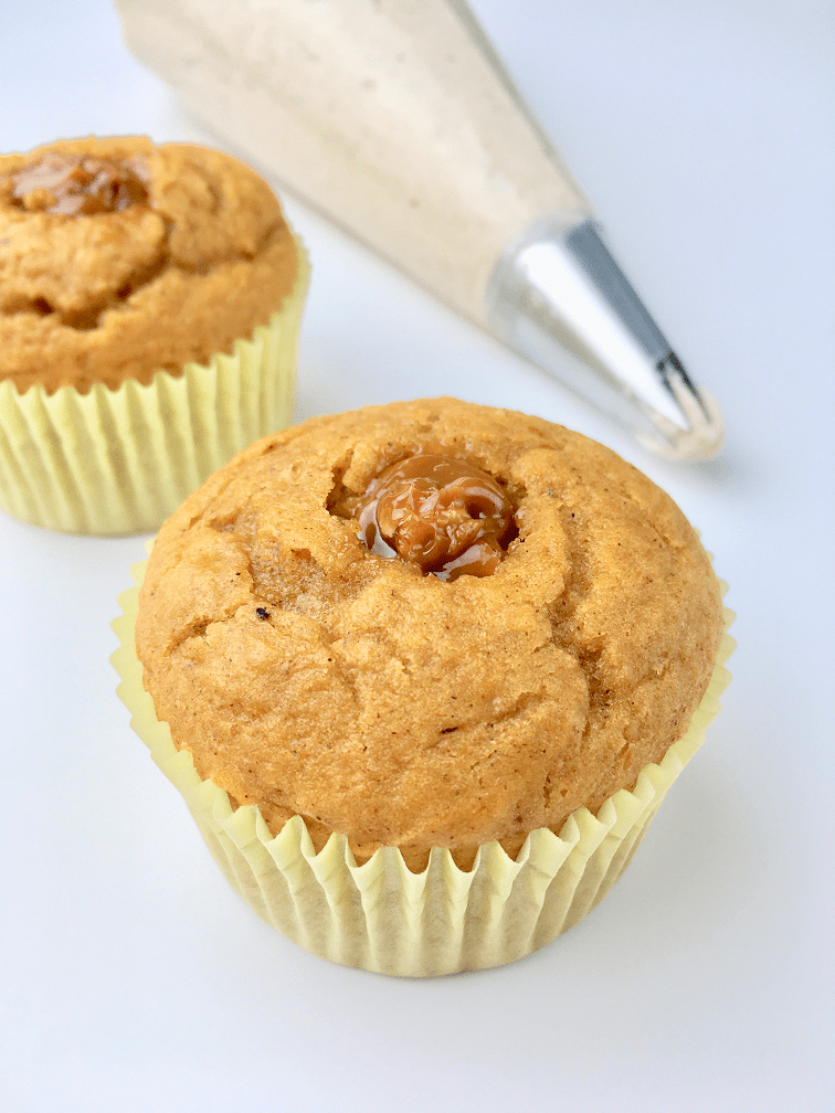 Pumpkin cupcakes filled with dulce de leche ready for frosting