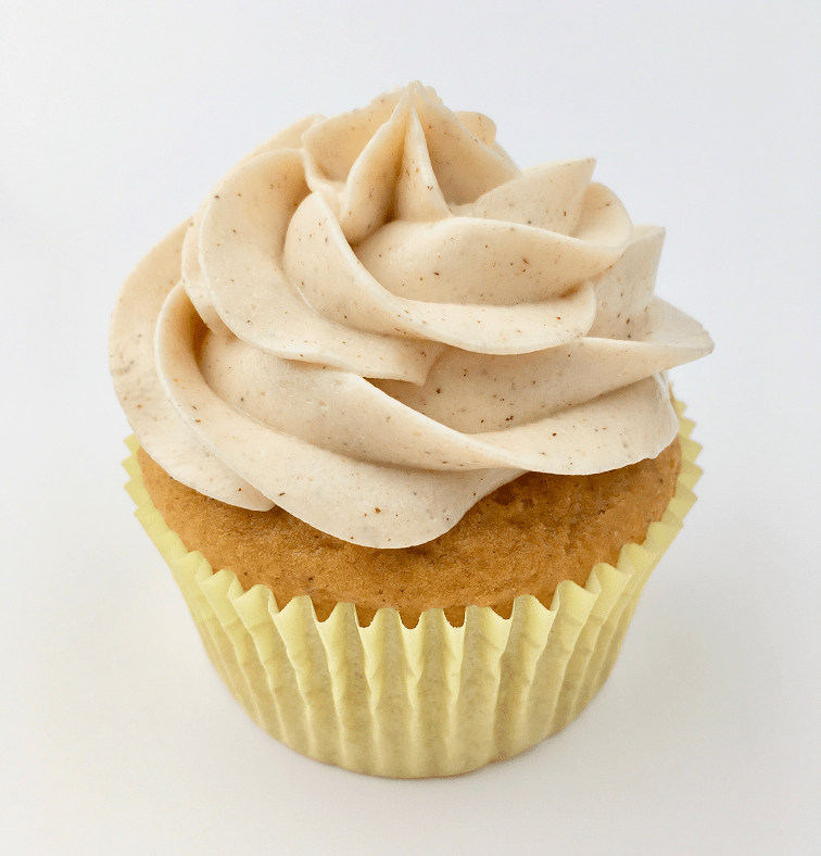 Close up of one pumpkin dulce de leche cupcake with cinnamon cream cheese frosting