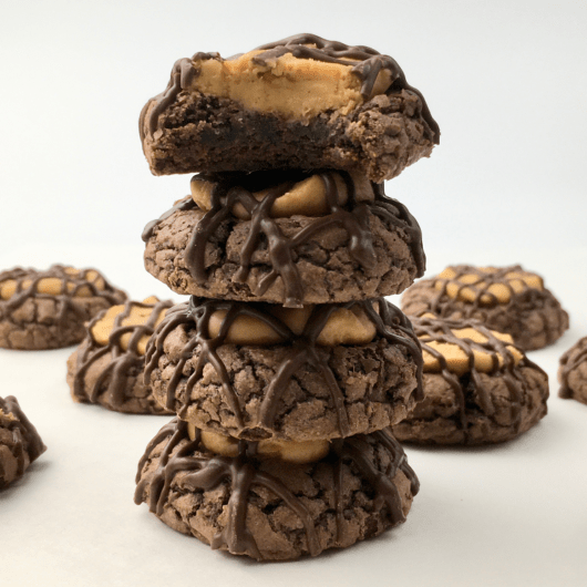 Stack of buckeye cookies surrounded by more buckeye cookies