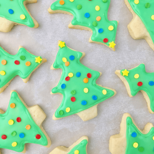 Christmas tree sugar cookies decorated with green icing and sprinkles