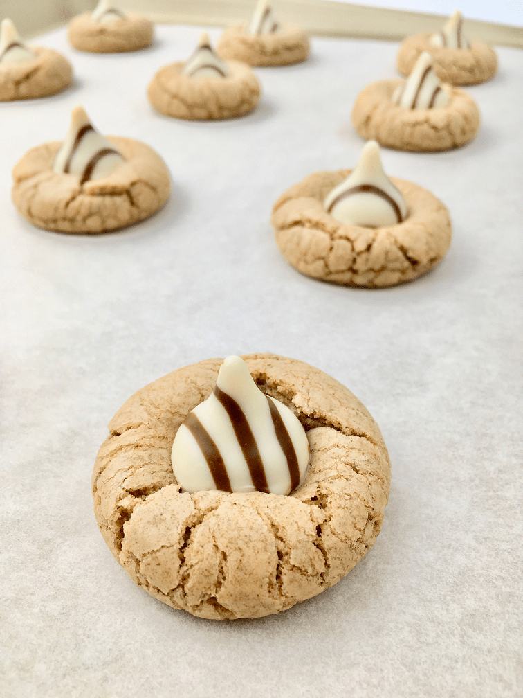 Baked gingerbread cookies with a Hershey’s Hug pressed into the center