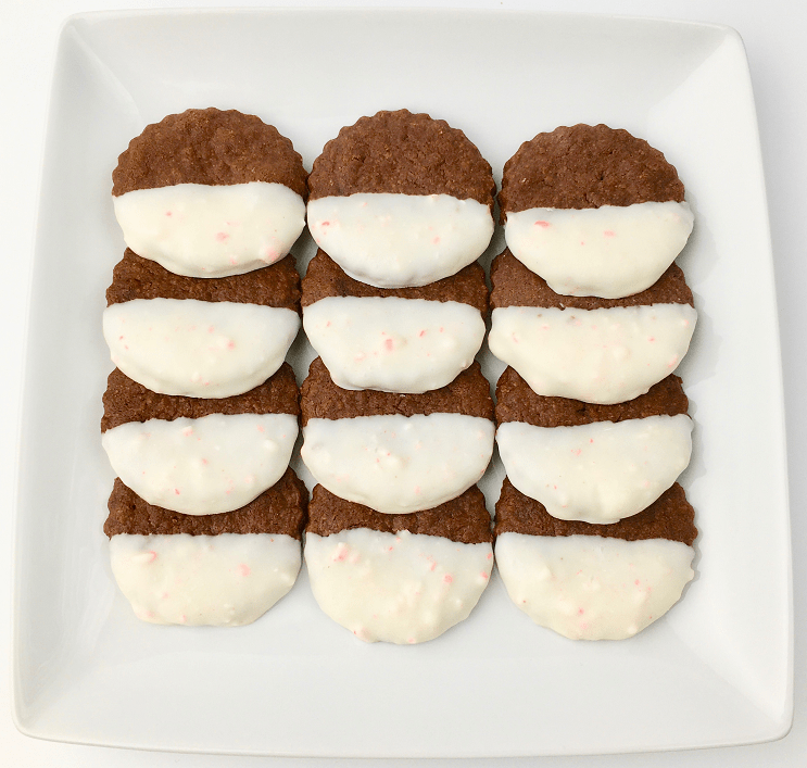 Rows of peppermint bark shortbread cookies arranged on a white plate