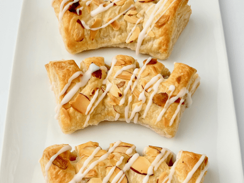 Finished bears claws in a row on a white plate