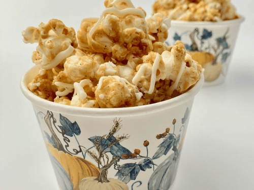 Maple spice caramel corn in a paper cup.