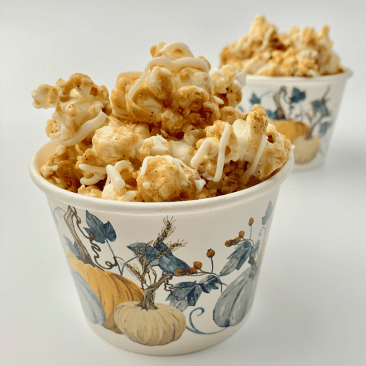 Maple spice caramel corn in a paper cup.