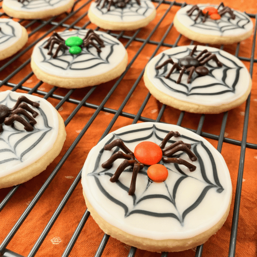 Close up of finished spider web cookie with chocolate spider.