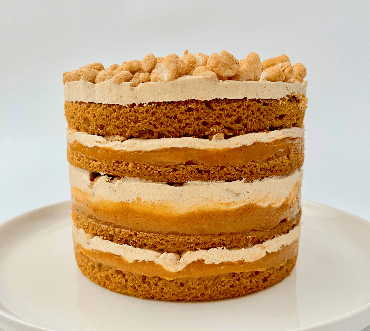 Finished pumpkin pie layer cake on a plate.