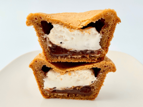 Deep dish smores cookie cut in half with marshmallow and chocolate filling.