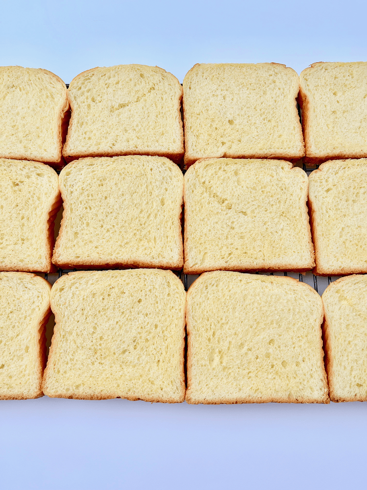 Slices of brioche bread on a wire rack.