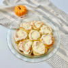 Finished pumpkin pie cinnamon rolls in glass pie plate.