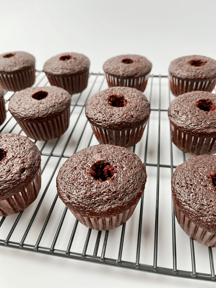 Chocolate cupcakes with an indentation in the top.