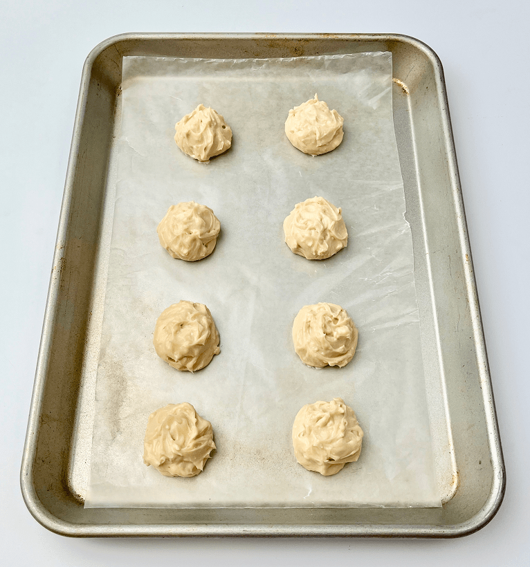 Scoops of maple cream cheese on a baking pan.